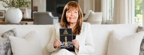 Polly Harder holding The King Reigns